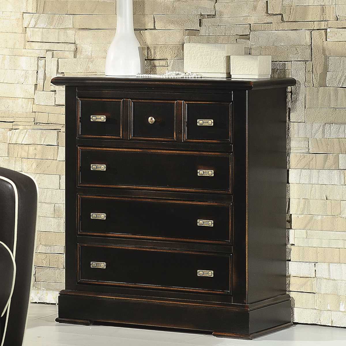 small classic handcrafted wooden chest of drawers in ruined black lacquered